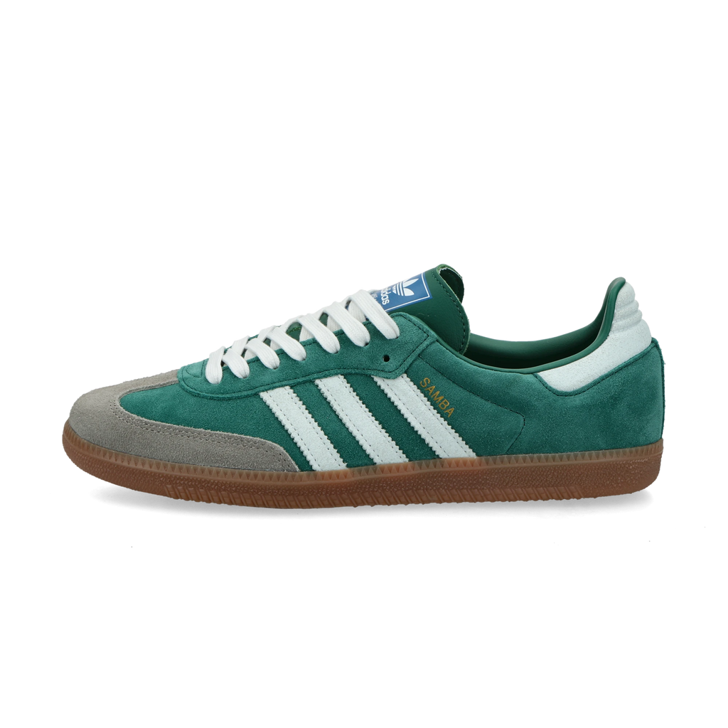 Adidas Samba OG Collegiate Green Gum Grey Toe.
Denne sneaker er perfekt til at skille sig ud på gaden. Den kommer i en smuk grøn farve og skiller sig bestemt ud fra mængden. Køb denne lækre sneaker her hos os.
set fra siden